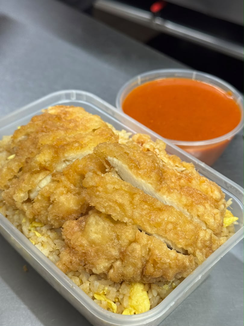 Crispy golden chicken katsu served over egg fried rice with curry sauce