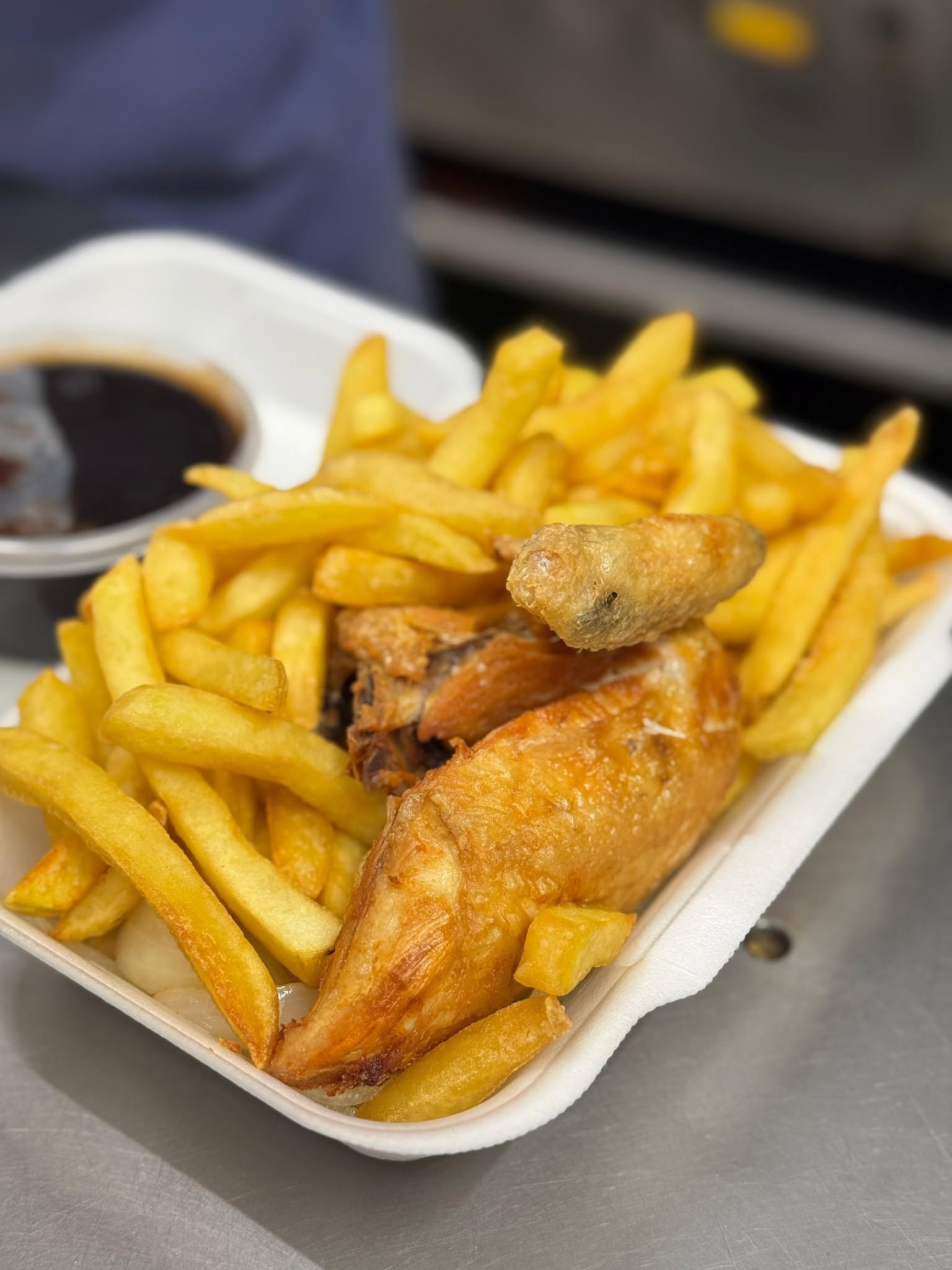 Roast chicken dinner served with chips and sauce